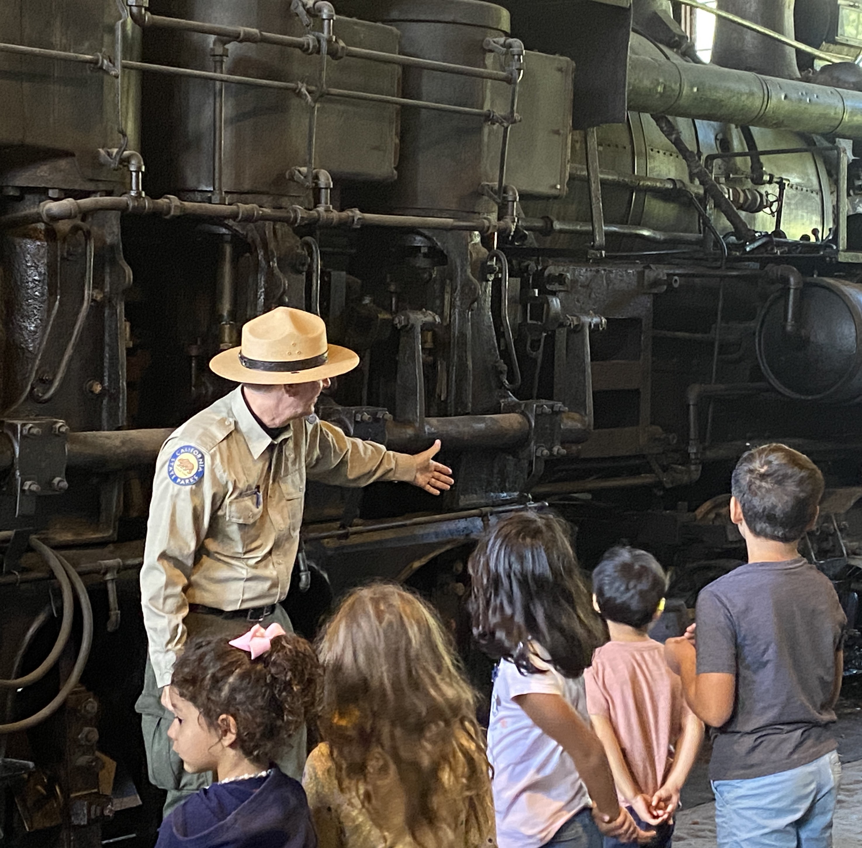 Tour guide presenting steam locomotive
